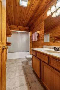 The second bathroom features a single vanity and a sliding door shower-tub combo, providing versatility and space efficiency. 4485 Coconut Ridge Smithville, TN 36166