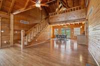 A cozy cabin-like living room with rustic wood paneling and exposed beams!  4485 Coconut Ridge Smithville ,TN 36166