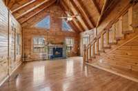 At the heart of the room is a stone or brick fireplace, creating a warm, inviting focal point that adds to the cozy atmosphere. 4485 Coconut Ridge Smithville, TN 36166