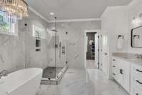 retreat to the primary bedroom a spa-like tile shower, and a soaking tub.