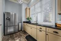 This is a real Laundry Room with granite counters, undermount stainless steel sink, double door stainless steel fridge and ice machine.