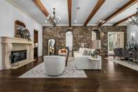 From the wood beams, to the stone wall, to the fireplace, this is a cozy space to hang out and entertain.