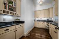 Granite counters, custom cabinetry, under cabinet lighting and natural light, what more could you need in a home Office!
