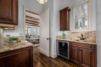 This is a two-sided Butlers Pantry complete with granite counters, undermount stainless steel sink, beverage fridge and plenty of storage space. One side could be the coffee bar and the other for after dinner drinks.