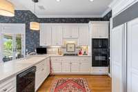 Kitchen with Sub Zero Refrigerator, granite countertops, and freshly painted cabinets.