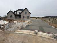 Oversized concrete driveway leading to 3 car garage