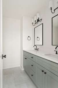 Double vanities in primary bath with black finishes