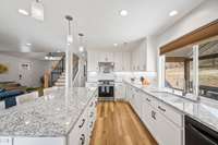 Dream Kitchen. Custom softclose cabinets, great storage, beautiful granite counter tops,  additional under the cabinet lighting, as well as pendent and can lighting, and the peaceful view of your acreage.