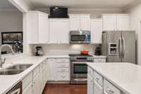 Quartz countertops and undermount sink.