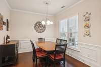 Dining area includes wainscoting.