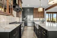 A chef’s dream! This stunning kitchen features two ovens, custom cabinetry, elegant lighting, and a spacious island. Designed for both function and style, it’s perfect for entertaining and creating culinary masterpieces.