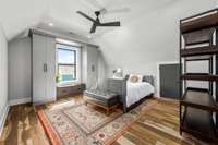 Second of four upstairs bedrooms, featuring brand-new custom California Closets, built-in storage, and a cozy window seat with stunning views.