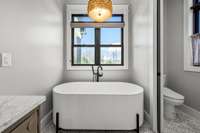 Spa-like luxury! The owner's ensuite features a stunning freestanding tub, dual vanities, and a walk-in shower with exquisite Italian tile. Thoughtfully designed for relaxation, this space offers the perfect retreat.
