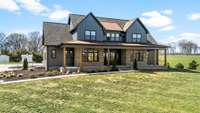 This stunning modern farmhouse blends luxury and charm on scenic acreage. With high-end finishes, an expansive porch, and breathtaking views, it offers elegance and comfort in a private setting. A rare opportunity for refined country living!
