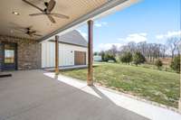 The covered back porch offers a peaceful retreat with scenic countryside views. Featuring ceiling fans for comfort, it's the perfect spot to relax or entertain while enjoying the spacious backyard.
