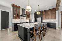 A chef’s dream! This stunning kitchen features two ovens, custom cabinetry, elegant lighting, and a spacious island. Designed for both function and style, it’s perfect for entertaining and creating culinary masterpieces.