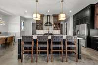 A chef’s dream! This stunning kitchen features two ovens, custom cabinetry, elegant lighting, and a spacious island. Designed for both function and style, it’s perfect for entertaining and creating culinary masterpieces.