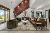 A living space designed to impress! This stunning living room features soaring ceilings, polished concrete floors, and a bold accent wall. Bathed in natural light, it offers the perfect blend of modern elegance and cozy sophistication.