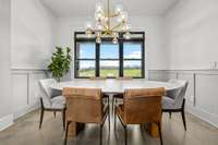 This formal dining room features stunning wainscoting, modern lighting, and a breathtaking countryside backdrop. The exquisite Restoration Hardware dining table conveys with the home, adding timeless sophistication to every gathering.