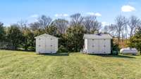 Two storage sheds provide ample space for tools, equipment, and outdoor gear. Both will convey with the property, offering convenient extra storage in the spacious backyard.
