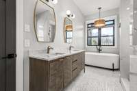 Spa-like luxury! The owner's ensuite features a stunning freestanding tub, dual vanities, and a walk-in shower with exquisite Italian tile. Thoughtfully designed for relaxation, this space offers the perfect retreat.