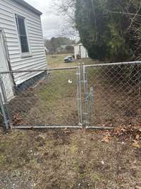 Right Side of the House with the Fenced in Backyard.