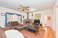 Large living area with 1 of 2 wood burning stoves to enjoy through the colder weather.