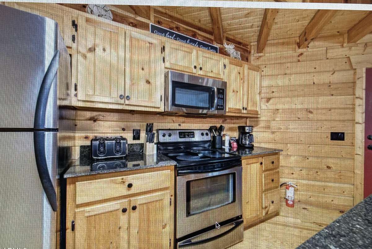 Beautiful knotty pine cabinetry in fully stocked kitchen. Coffee bar has been added (not pictured here)