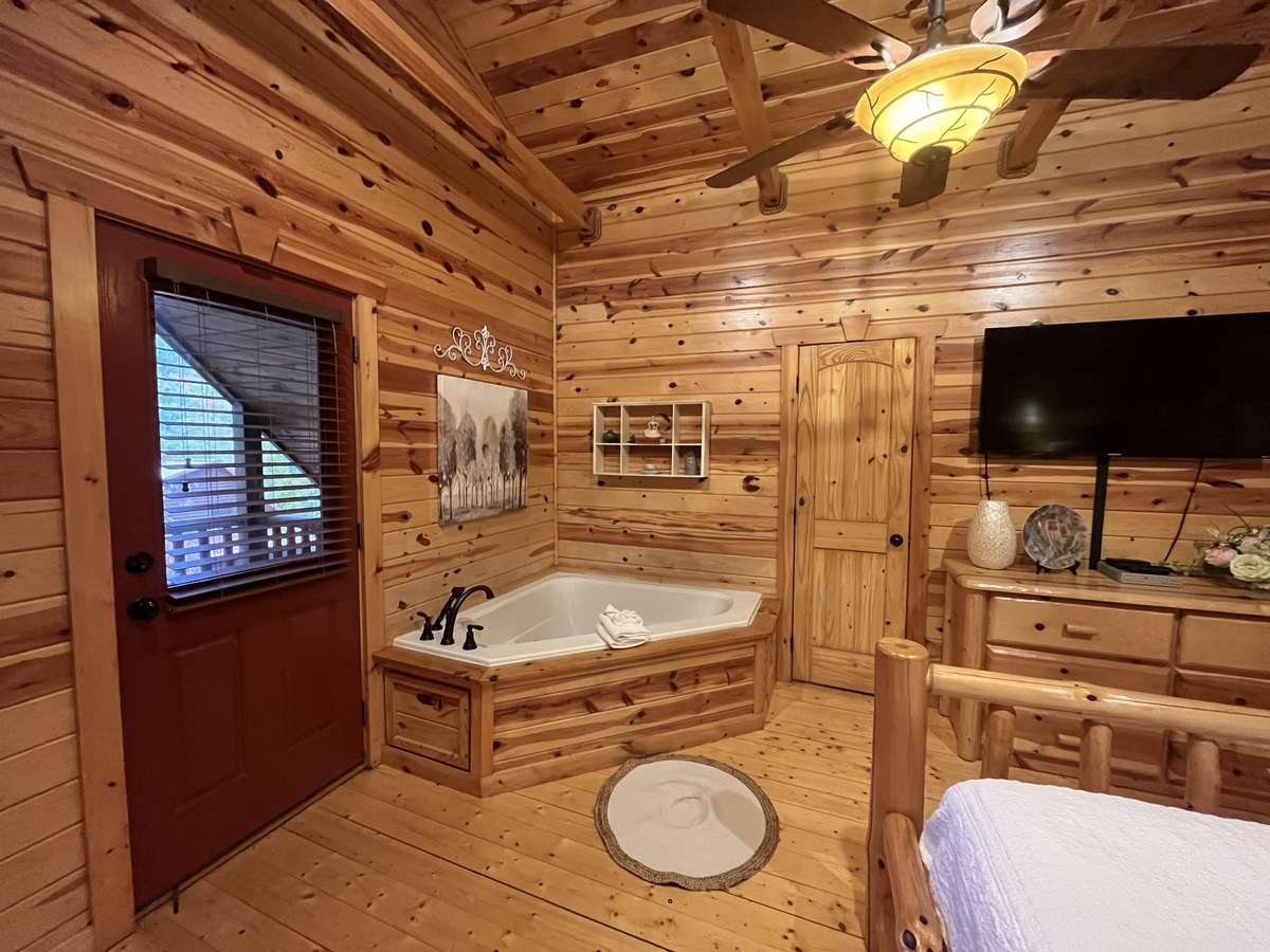 2nd Master showing spa tub and door leading to private balcony.