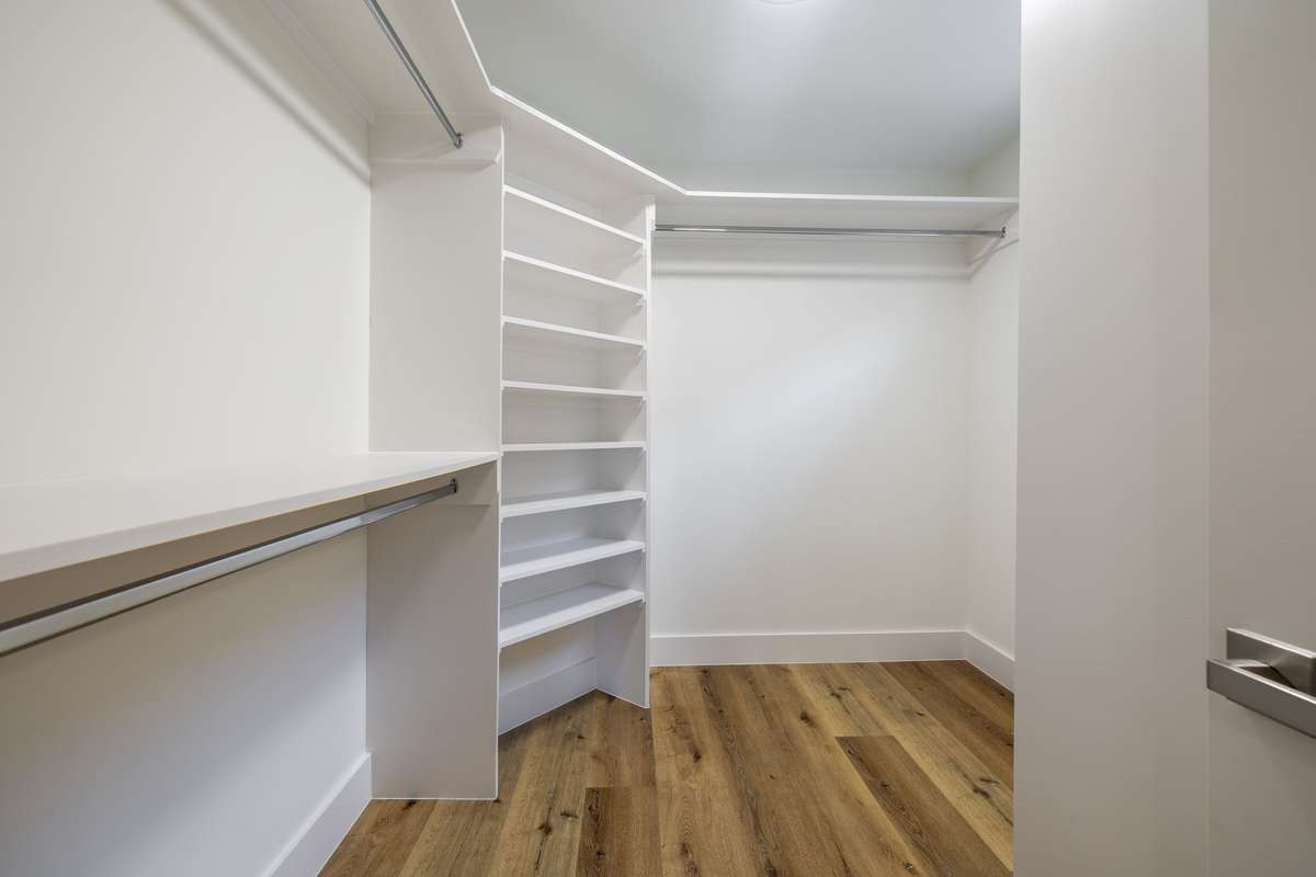 Primary bedroom closet with built in shelving