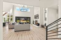 Open concept floorplan is scaled perfectly to your needs with soaring two story windows and wood details along the fireplace wall in the main living area