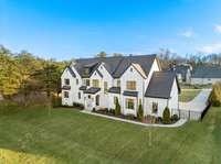 The HOA land buffer in the front provides even more of a front yard than exists that you do not have to maintain! Beautiful landscape lighting highlights the modern architecture by Juri Architectural Design, built by Jack Weissman