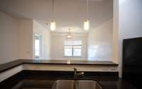 Open-concept kitchen, dining area, and living room.