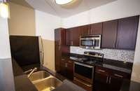 Modern backsplash and stainless steel appliances.