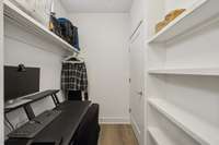 Spacious walk in closet with nice shelving and bar for hanging your clothes.