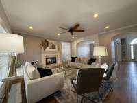 Another picture of the living room with views of the beautiful trim work, and see-through wood fireplace.