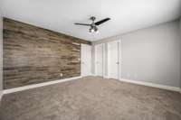 Bedroom 4 with accent wall, walk-in closet and bathroom