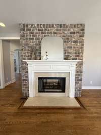 Fireplace in the kitchen with slivered brick accents.