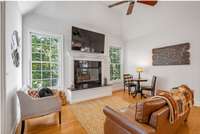 Another view of the living area with cozy fireplace adjacent to kitchen area.
