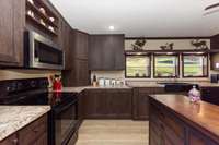 Generous Kitchen space with cabinets soaring to the ceiling