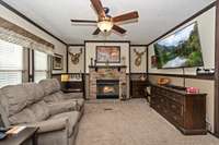 Spacious family room with a cozy fireplace to relax with