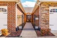 Enter through a lovely, gated courtyard, perfect for gardening or relaxing outdoors.