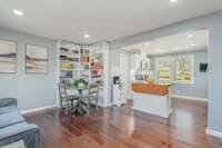 The beautiful kitchen features an island and a designated area perfect for a coffee station. Large windows offer a view of the spacious yard, bringing in plenty of natural light.