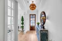 Entrance is sleek and inviting with oversized lighting for dramatic effect.