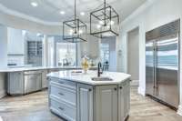 The kitchen offers plenty of prep space as well as a vegetable sink in the center island.