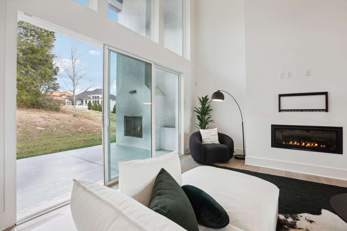 California Sliders opens great room to outstanding outdoor living and covered porch to treed backyard and common area