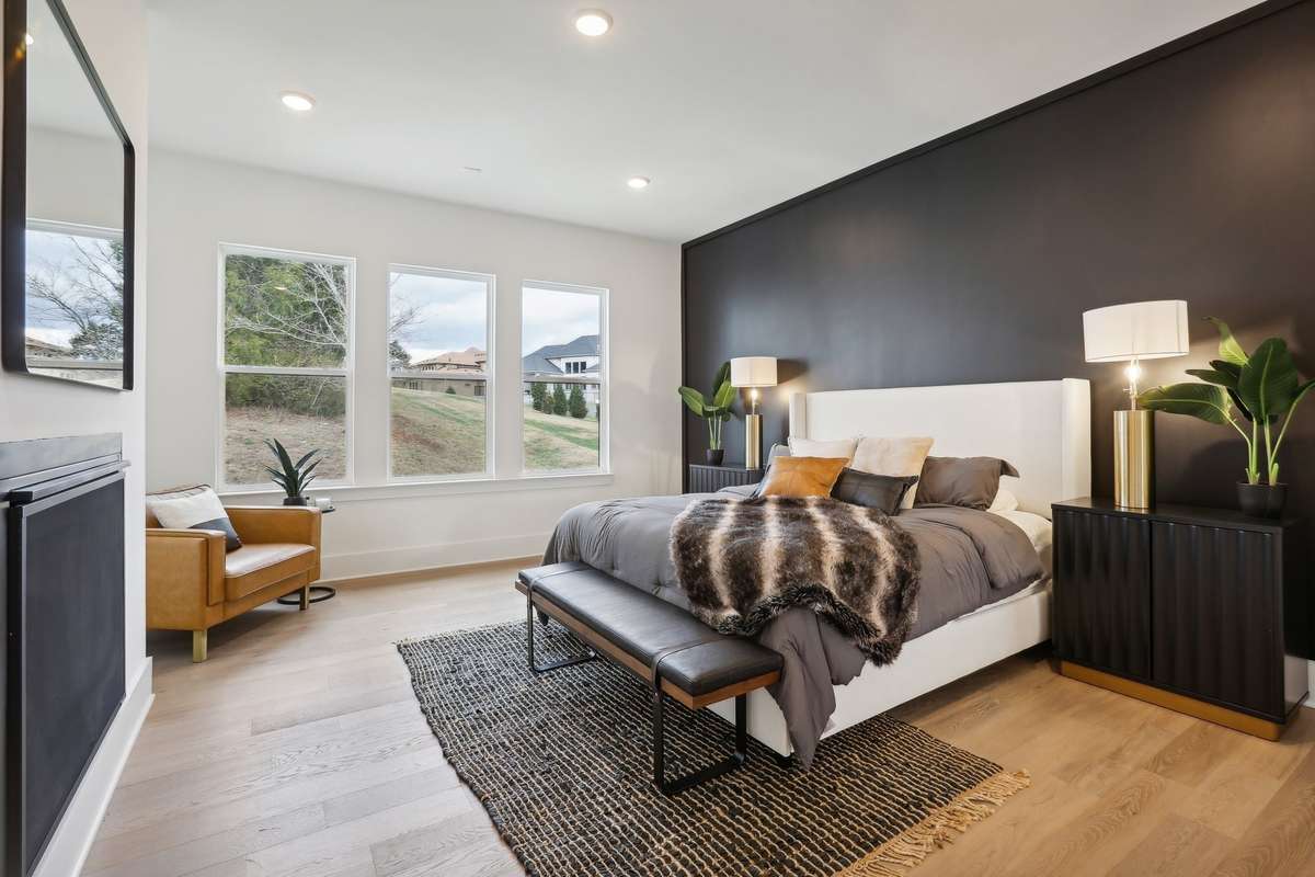 Primary bedroom with gorgeous wood custom wall
Treatment and romantic fireplace.  Beautiful view of woods in semi private back
Yard