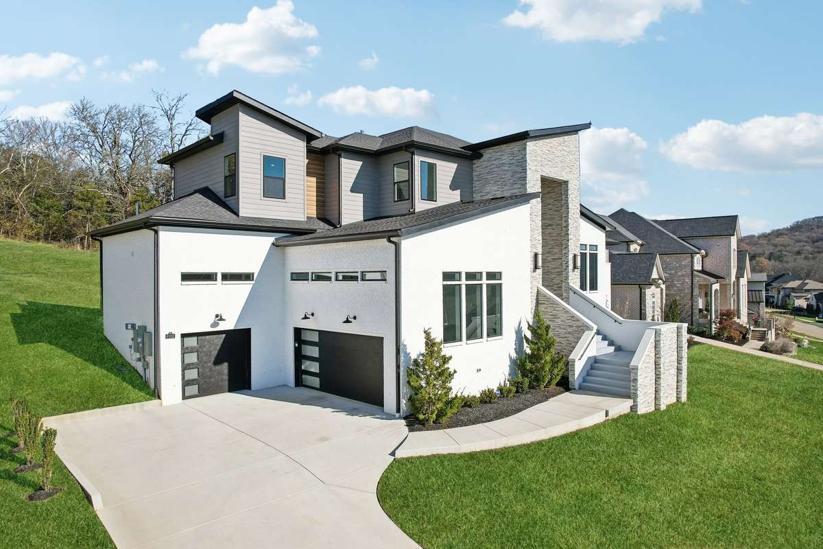 3 car garages that could accommodate 6 cars with fixture  added car lifts.  Boasts lots of natural light and potential storage plus additional parking space