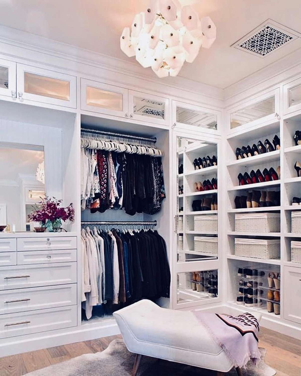 Virtually staged & envisioned primary closet with hardwoods