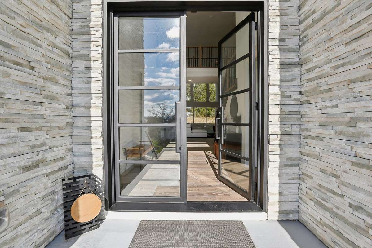 Custom metal double doors opening to soaring ceilings!